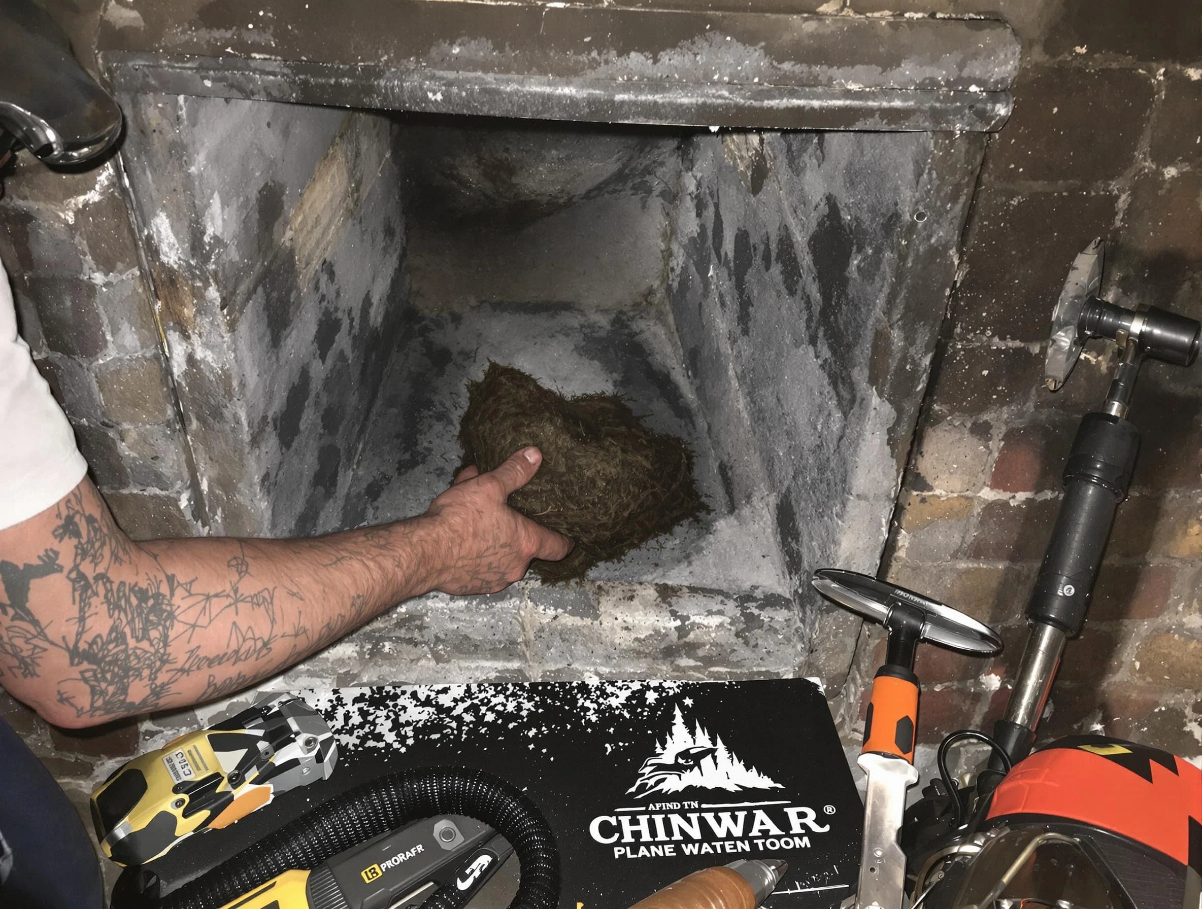 Suwanee Chimney Sweep safely removing debris and screening chimney in Suwanee, GA